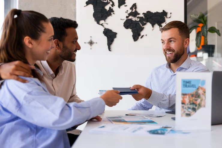 Couple receiving passports or travel documents from legal consultant.